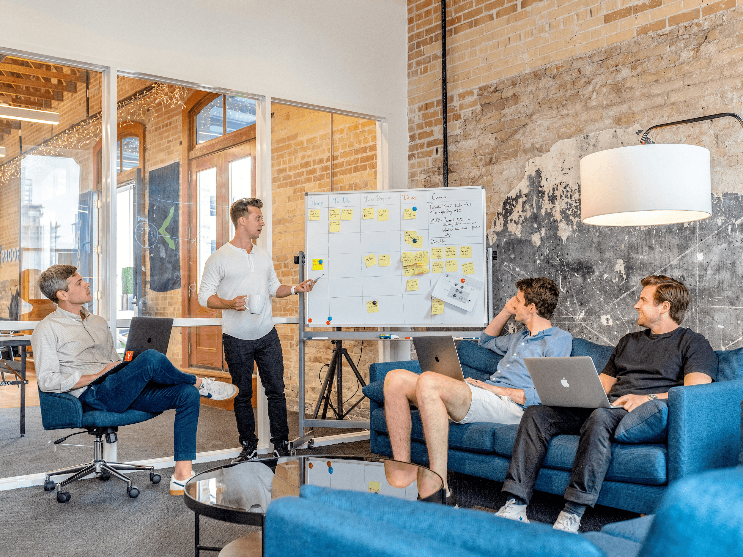 Team meeting in a modern office space with a whiteboard